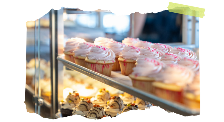 A tray of freshly baked chocolate and vanilla cupcakes in the Cupcake Company bakery